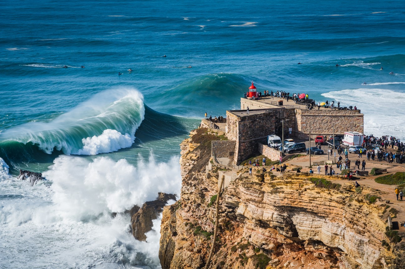 The Forte de São Miguel Arcanjo with a wave breaking to the left and surfers offshore