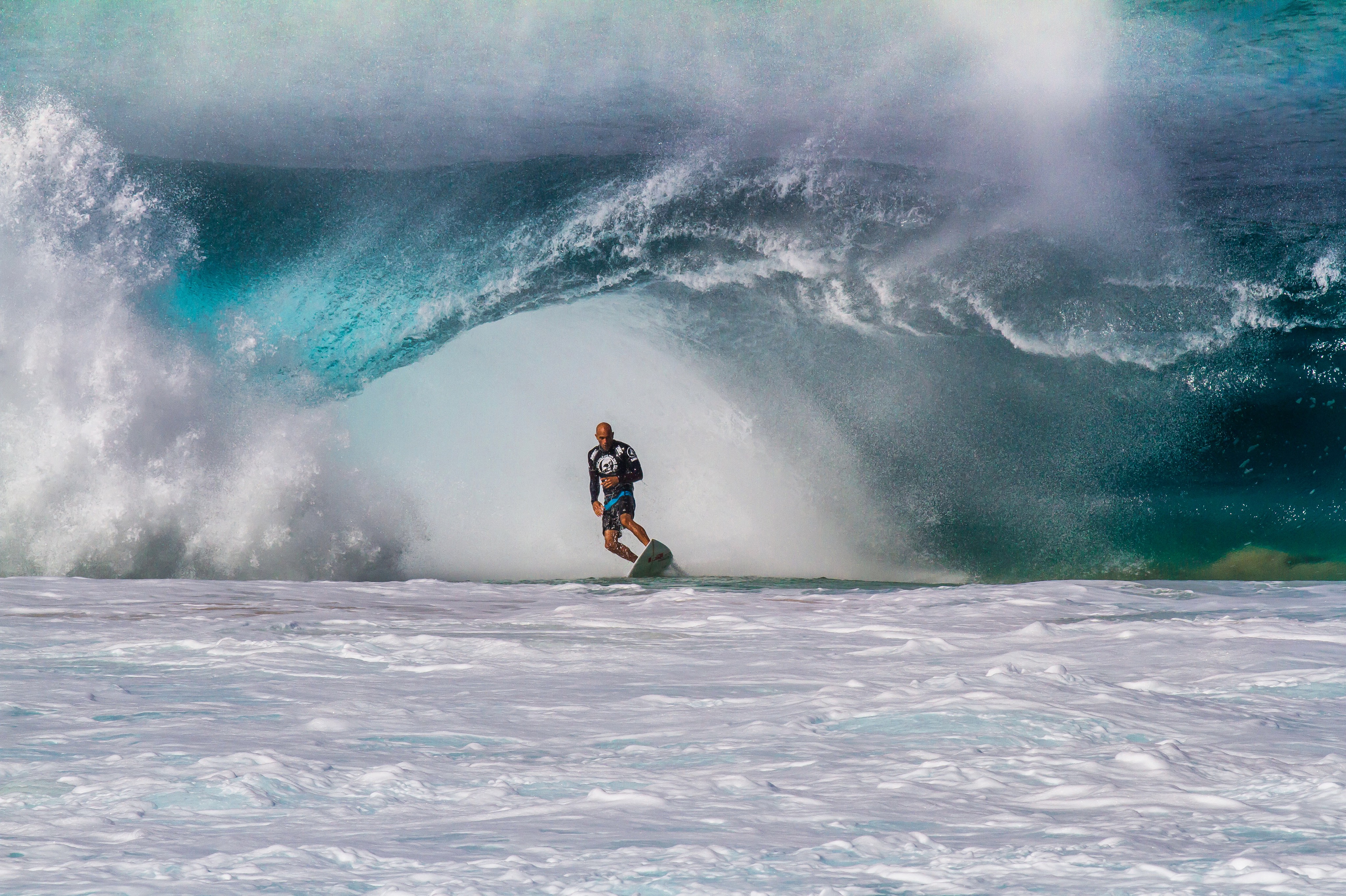 A surfer escaping the jaws of a Banzai Pipeline wave