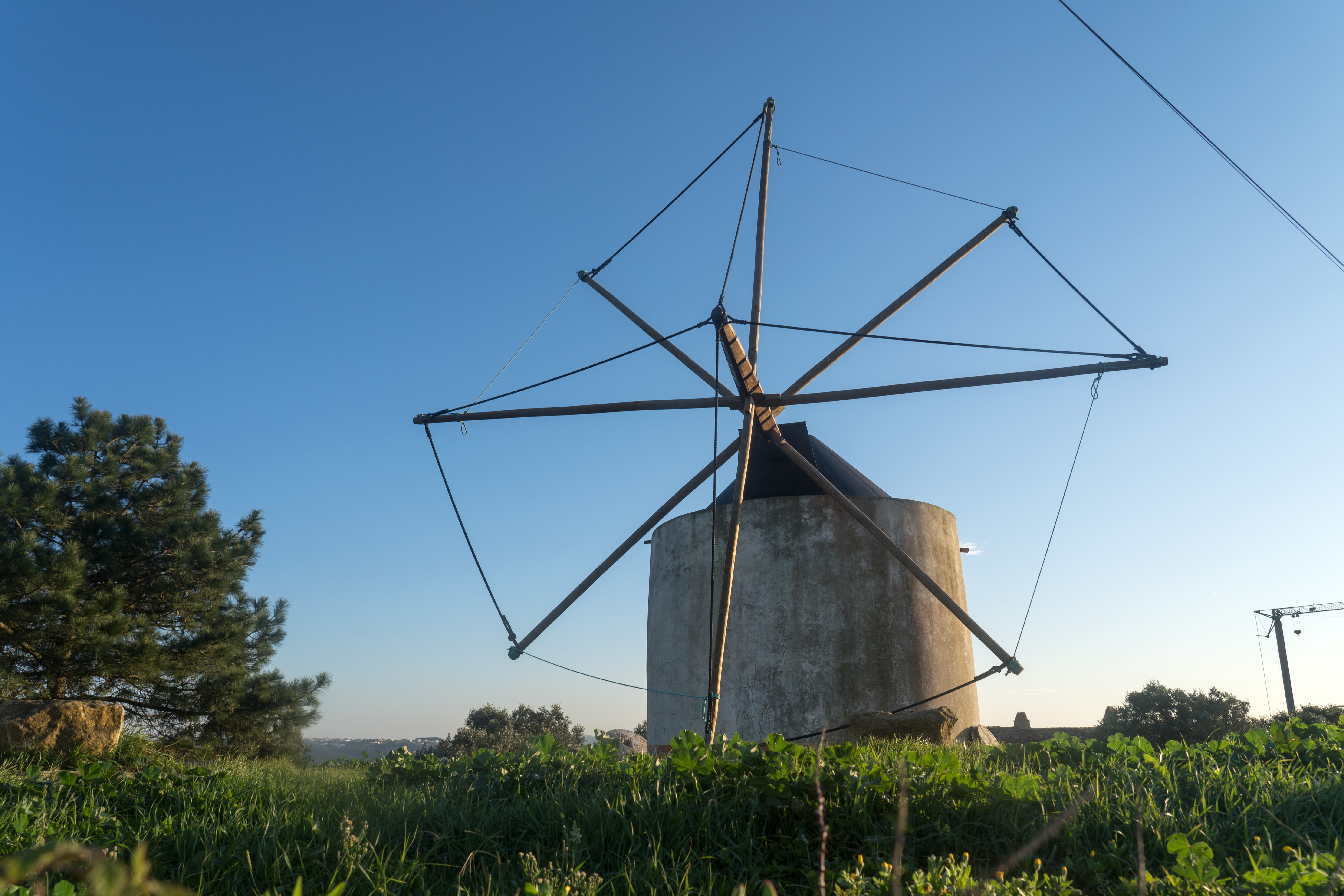 A traditional Portuguese windmill on the hills above the bay